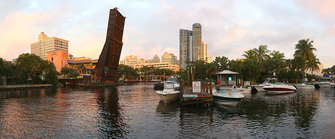 High-rise towers beside the New River with a raised drawbridge at sunset in downtown Fort Lauderdale